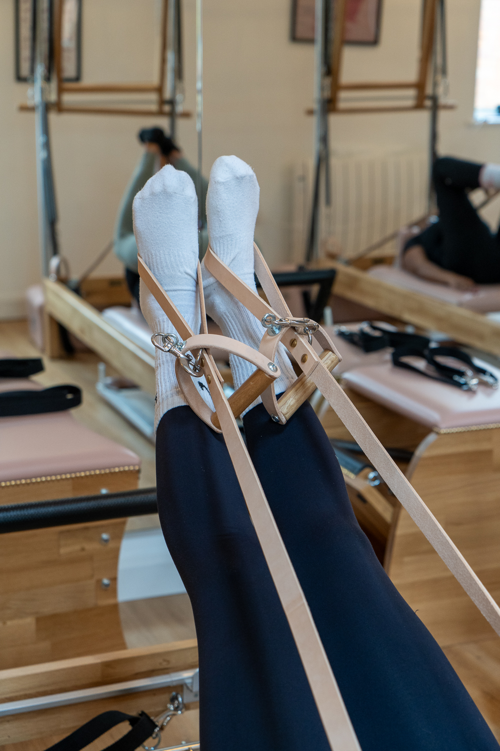 Feet in reformer straps